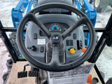 operator view of steering wheel and dash inside the cab of an LS MT347 tractor