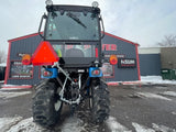 rear view of an ls mt225s tractor with cab installed at super x power an ls dealer in mn